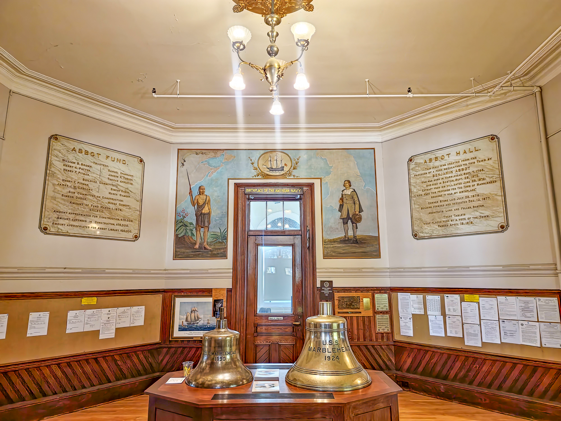 Interior of Abbot Hall with USS Marblehead ship bells and maritime murals